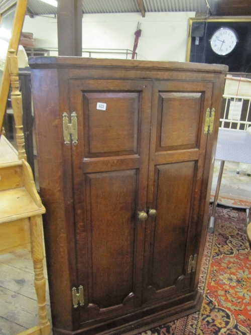 A 19th century large oak corner cupboard with fitted interior.
