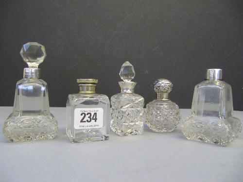 Five various silver topped glass perfume bottles.