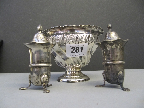 A pair of silver pepperettes together with a pedestal silver sugar bowl (162 grams).