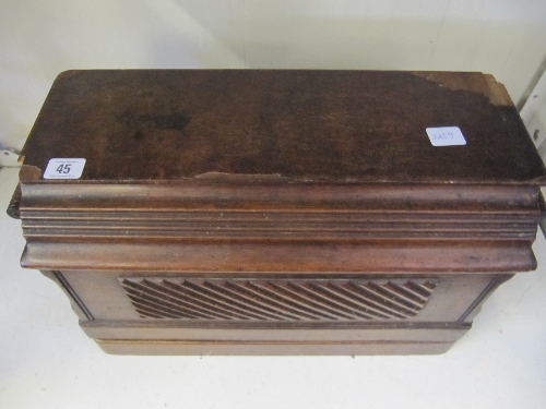 An early 20th century Singer sewing machine in original oak case.