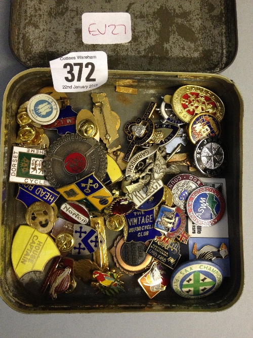 A tin of badges.