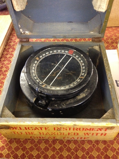 A Military compass in wooden box.