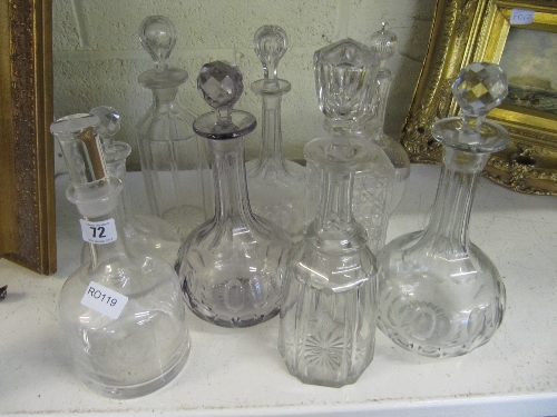 Nine various glass decanters.