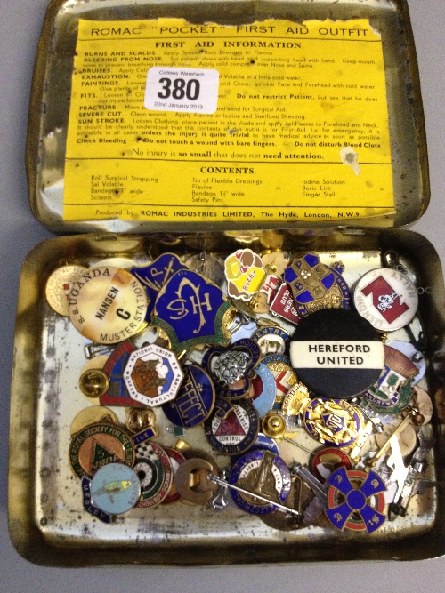 A tin of badges.