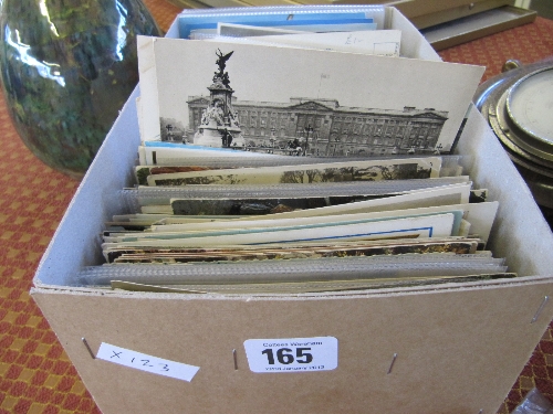 A box of unsorted postcards.