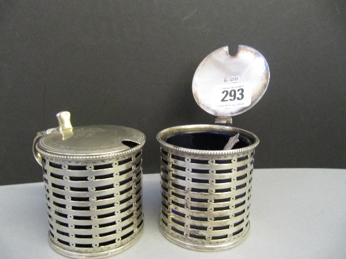 A pair of large silver mustard pots with hinged lids and blue glass liners by Daniel & John Wellby