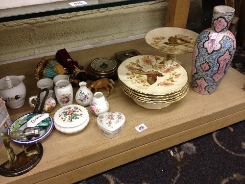 A shelf containing various china and other items together with the residue of a 19th century dessert