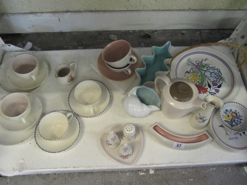 A shelf of Poole Pottery.