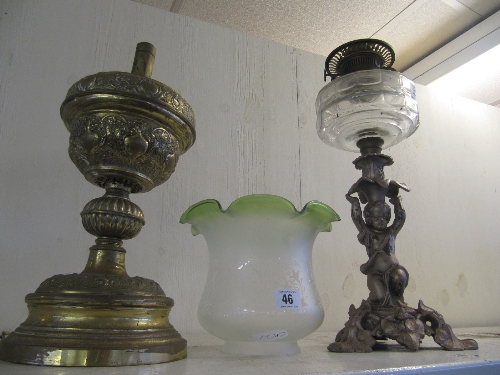 A late 19th century oil lamp base on spelter putti column together with a brass oil lamp base and