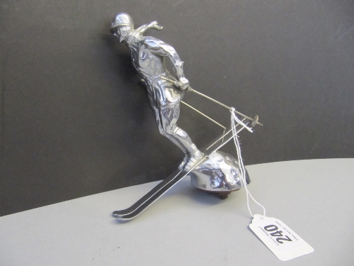 A large early 20th century silver plated car mascot modelled as a female skier: The Riley Skilady,