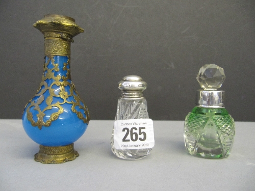 Three various glass scent bottles with silver and brass mounts.