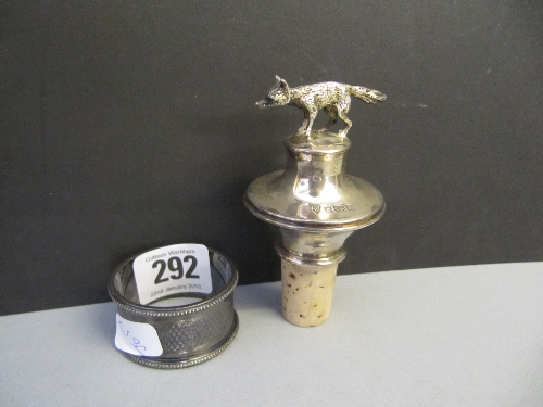 A 20th century silver wine bottle stopper with fox mount together with a napkin ring.