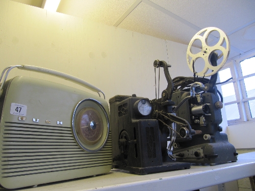 A Bush radio together with two early 20th century cine projectors.