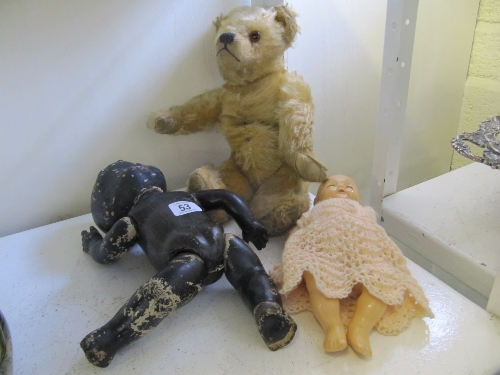 A mid 20th century jointed English teddy bear together with two dolls.