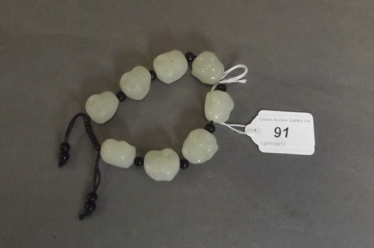 A Chinese carved jade 7 bead rosary, 8'' long