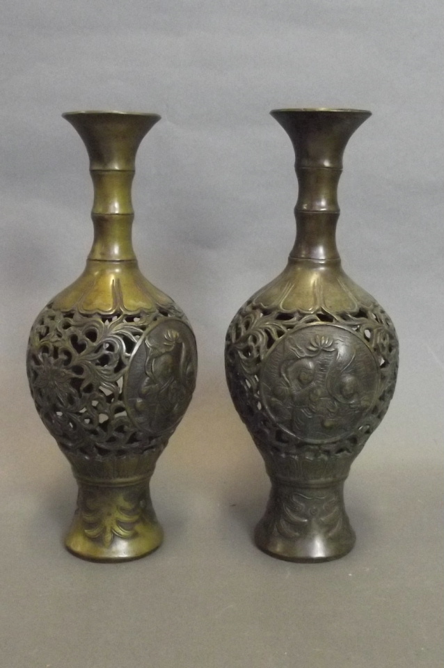 A pair of Japanese reticulated pierced bronze vases with figural decorative panels to side,