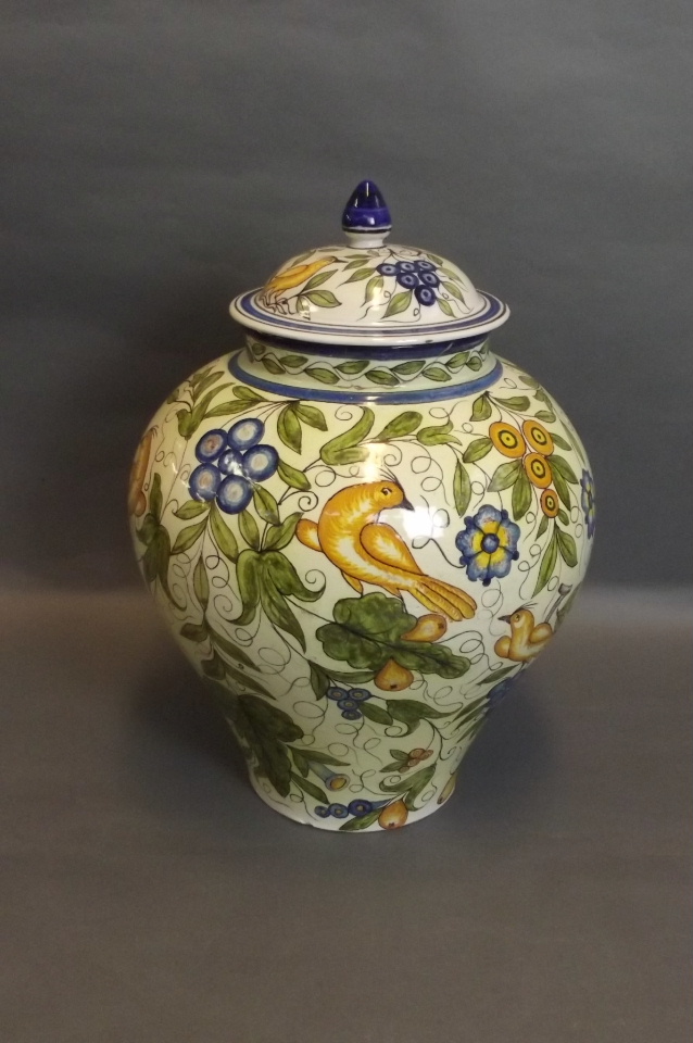 A large Cantagalli bulbous shaped jar and lid with polychrome decoration of birds amongst fruiting