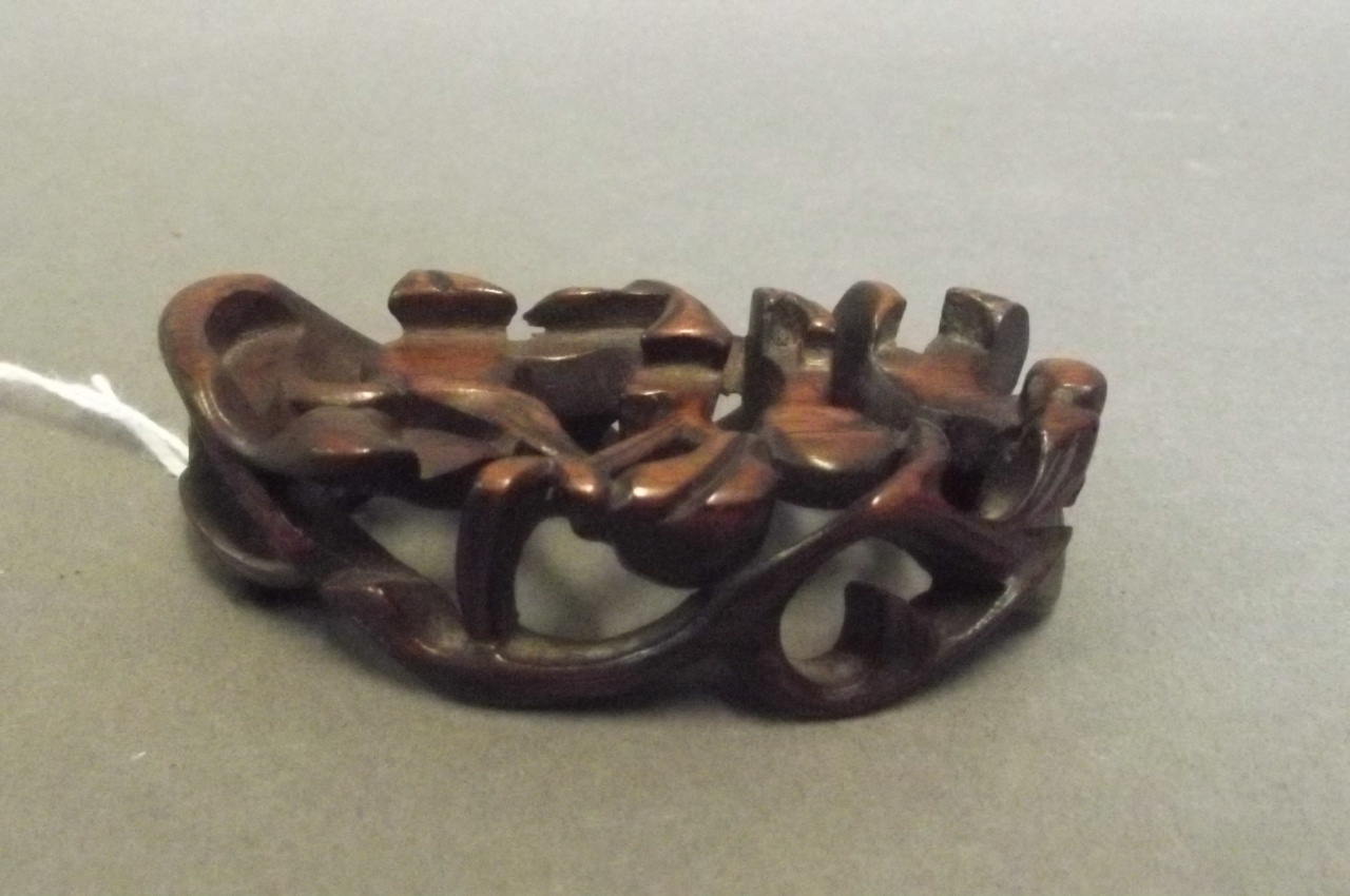 A Chinese carved and pierced hardwood wrist rest, 3'' x 1½''