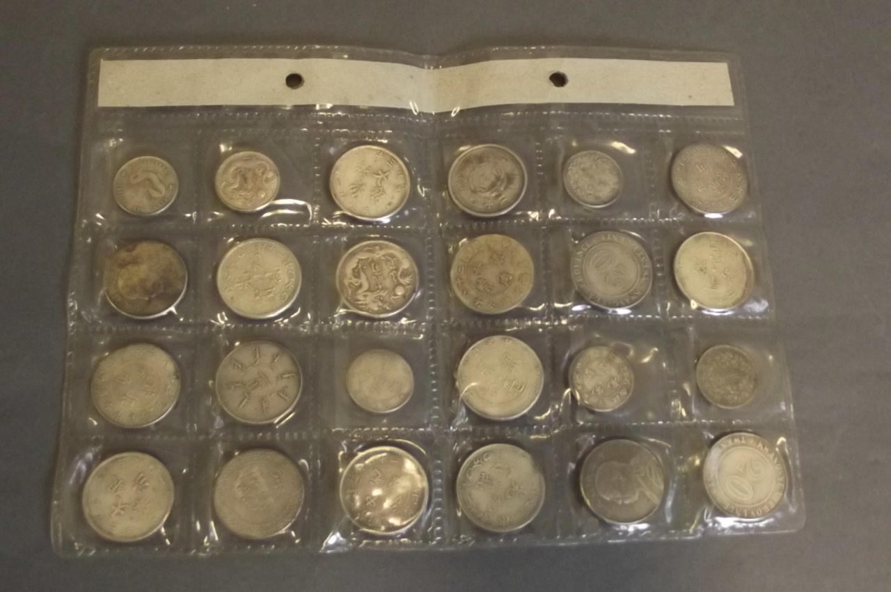 Twenty-four Chinese silvered metal coins