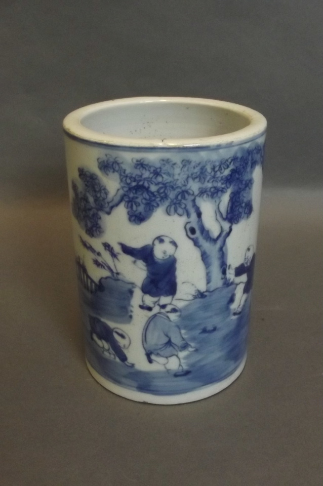 A Chinese blue and white brush pot with painted decoration of children playing in a garden, 5½'' x