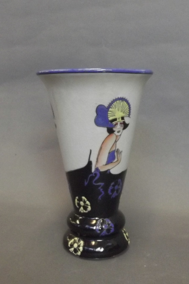 An Art Deco style porcelain vase with fashionable ladies to sides and flowers to base, 8½'' high