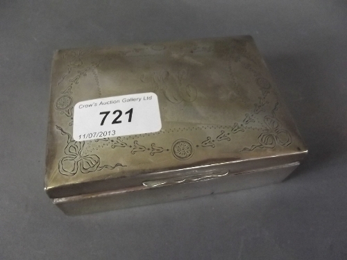 A Hallmarked silver cigarette box with engraved decoration, 4½'' wide