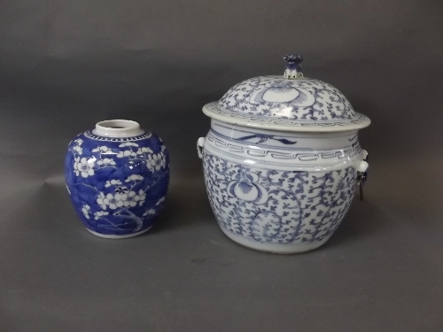 A Chinese blue and white jar and cover decorated with lotus flowers and a Fo dog knop to lid, and