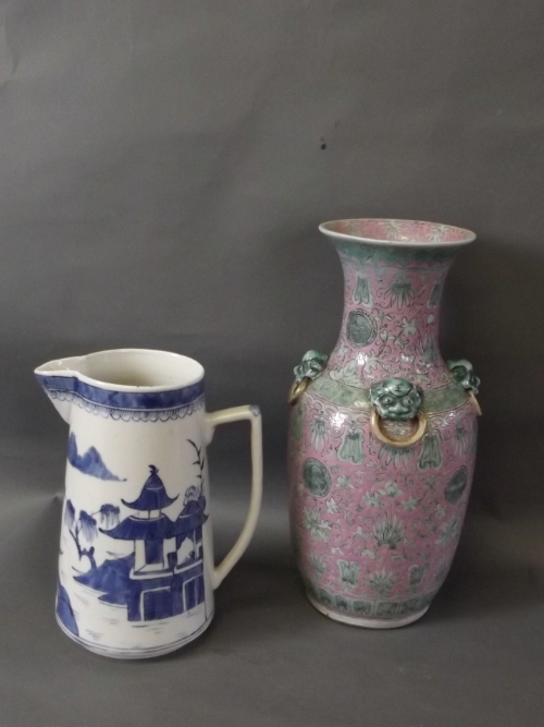 A pink ground Chinese vase with applied dog's head handles to neck and green floral decorations to