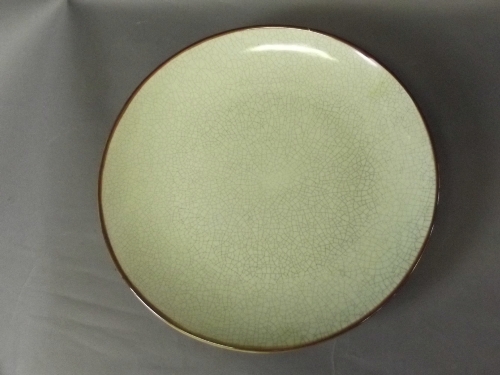 A green ground crackle glazed charger with brown glazed rim, 14'' diameter