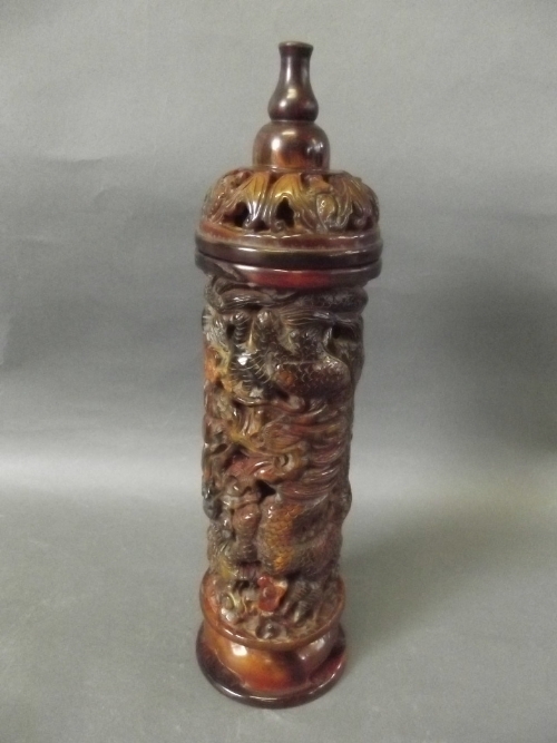 A Chinese pierced horn incense holder decorated with carved dragons and bats, 11'' high