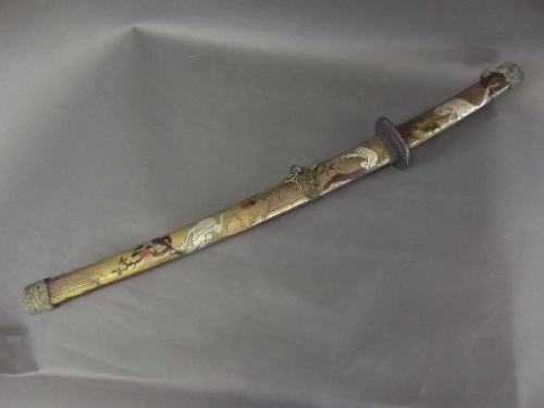 A Japanese short sword with a cold enamelled handle and inscription to blade, decorated with monkeys