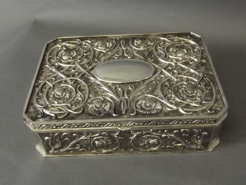 A silver plated jewellery box with fitted inside and flower decoration to lid and sides, 9½'' x 7''