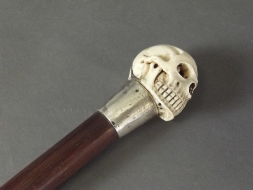 A carved ivory topped walking stick in the form of a skull with shibiyama decoration and