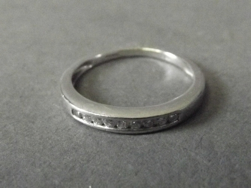 An 18ct white gold diamond half eternity ring, size M