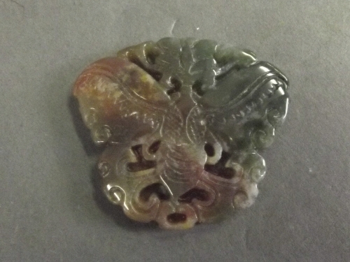 An antique carved jade pendant carved as a butterfly, 1¾'' high