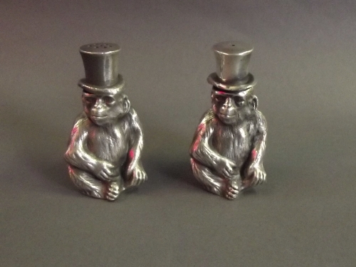 A pair of silver plated salts in the form of monkeys wearing top hats, 2¾'' high