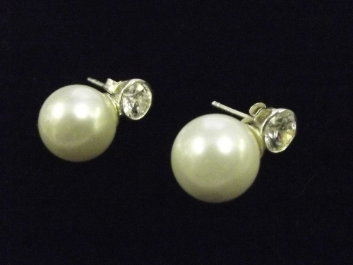A pair of silver, shell, pearl and white stone stud earrings