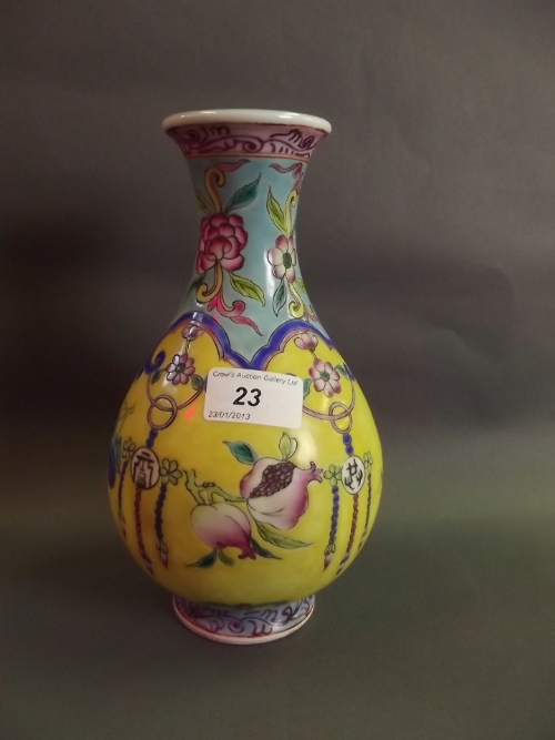 A Chinese porcelain vase with blue and yellow ground with bursting pomegranate decoration, seal mark