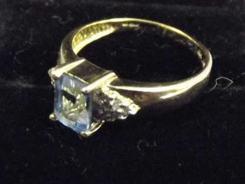 A 9ct gold ladies ring set with blue topaz and diamonds, size O