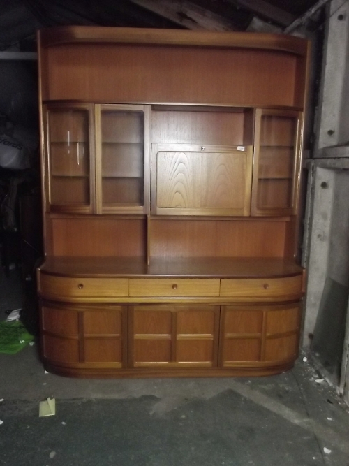 A 1970s teak shaped dining room bookcase/cabinet, 60'' wide, 76'' high