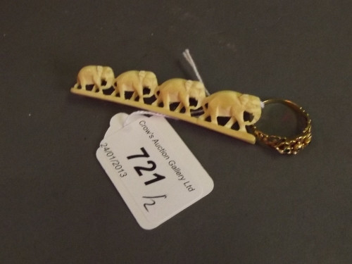 An early C20th 3 stone diamond set gold ring, and a carved ivory elephant brooch