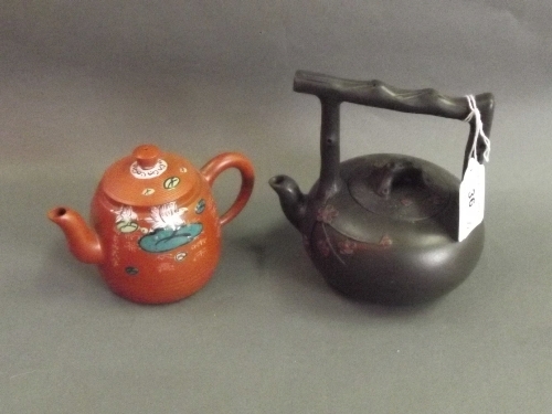 A Chinese Yixing teapot with enamel glazed decoration and another with faux bamboo decoration,