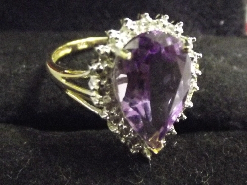 A 9ct gold ladies cocktail ring, with pear shaped amethyst and diamond mount, size P