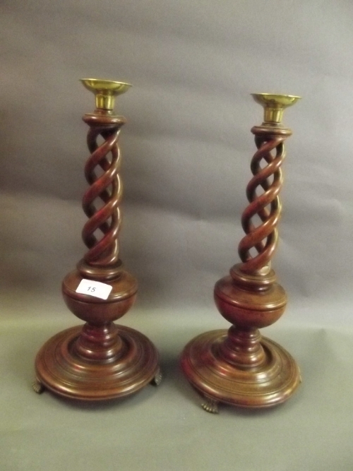 A pair of mahogany barley twist candlesticks with brass nozzles, 15'' high