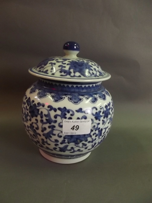 A Chinese porcelain jar and cover with blue and white decoration of trailing lotus flowers, seal