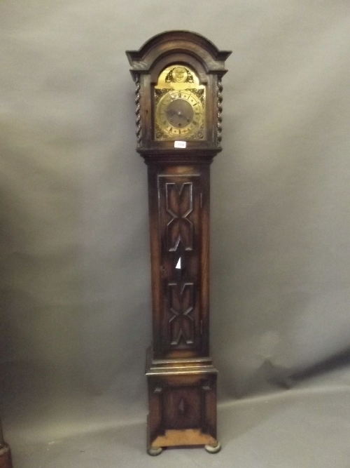 A 1930s oak grandmother clock with a brass arched dial, Jacobean style case, 64¼'' high