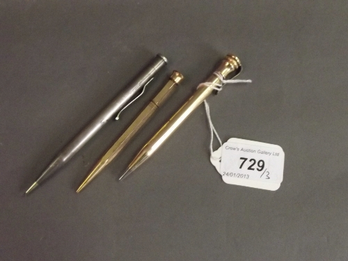 A Hallmarked silver propelling pencil and 2 gold plated propelling pencils