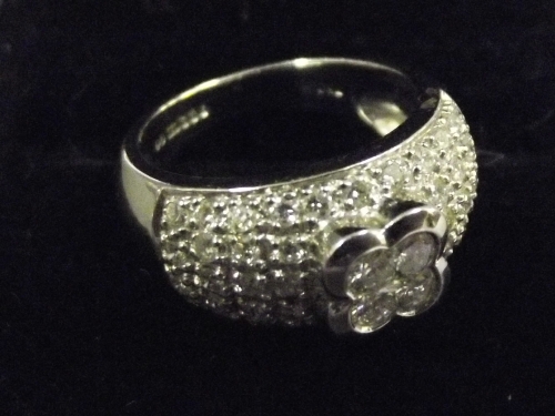 An 18ct heavy white gold ladies dress ring with 4 diamonds set with a diamond cluster bond, size M