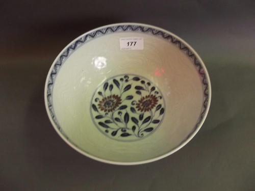 A good Chinese blue, red and white pottery bowl, with incised decoration, painted with stylized