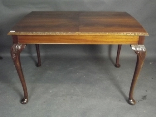 An early C20th mahogany extending dining table with an extra leaf, on cabriole legs, 45'' x 33''